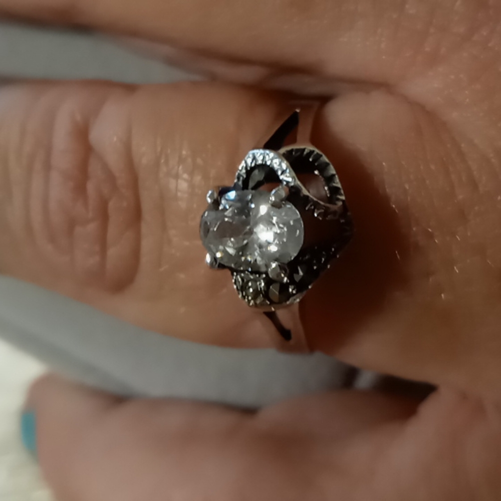 Truly a rose. Oval cut CZ set in 925 sterling silver setting with pave diamonds.
